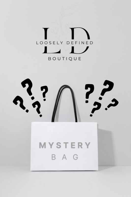 Mystery bag with question marks and 'Loosely Defined Boutique' branding on a light gray background